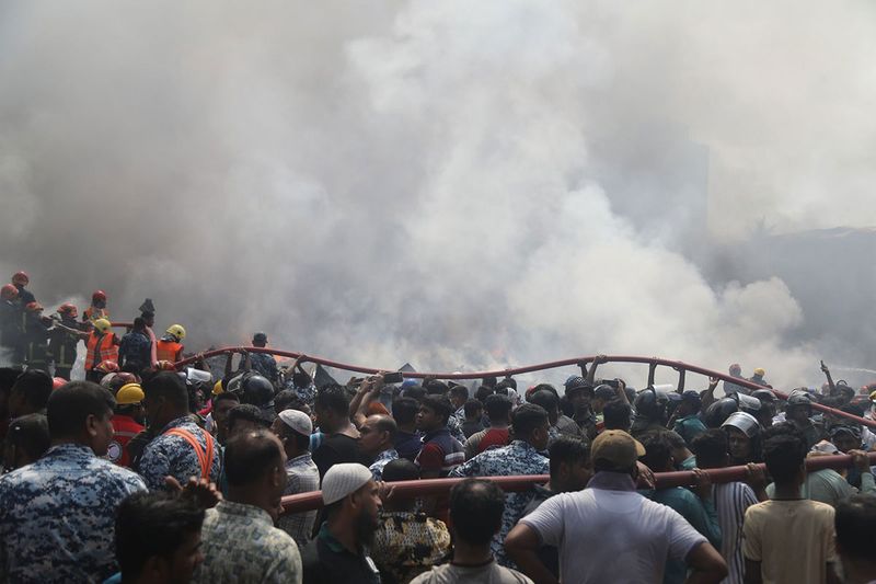 Firefighters, rescue workers, and helpers work to extinguish a fire at the Bangabazar market in Dhaka, Bangladesh, on Tuesday, April 4, 2023. The Bangabazar market is one of the largest shopping places in the capital Dhaka for cheaper clothes — a labyrinthine structure that has hundreds of shops.