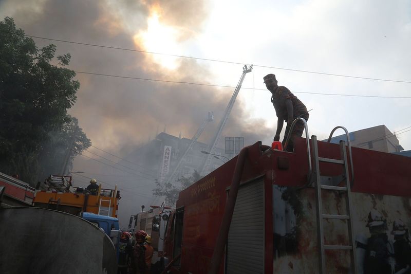 Firefighters work to extinguish a fire at the Bangabazar market in Dhaka, Bangladesh, on Tuesday, April 4, 2023. The Bangabazar market is one of the largest shopping places in the capital Dhaka for cheaper clothes — a labyrinthine structure that has hundreds of shops. 