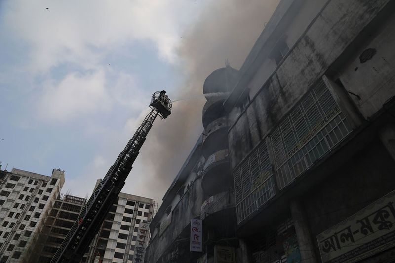 Firefighters work to extinguish a fire at the Bangabazar market in Dhaka, Bangladesh, on Tuesday, April 4, 2023. The Bangabazar market is one of the largest shopping places in the capital Dhaka for cheaper clothes — a labyrinthine structure that has hundreds of shops.