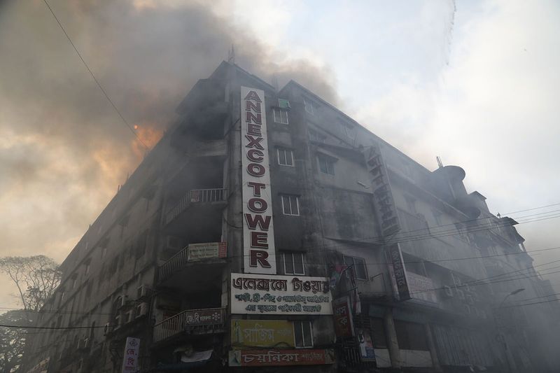 Smoke fills the air during a fire at the Bangabazar market in Dhaka, Bangladesh, on Tuesday, April 4, 2023. The Bangabazar market is one of the largest shopping places in the capital Dhaka for cheaper clothes — a labyrinthine structure that has hundreds of shop