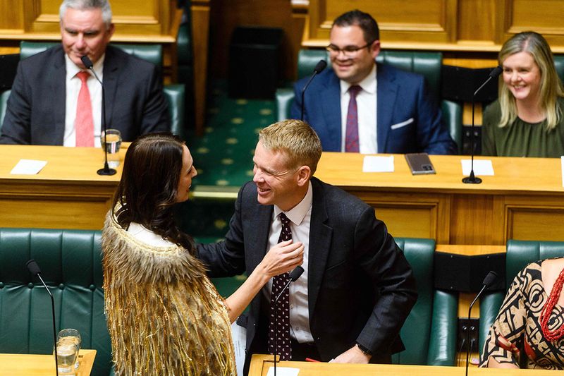 Outgoing New Zealand prime minister Jacinda Ardern hugs Zealand Prime Minister Chris Hipkins during her valedictory speech in parliament in Wellington on April 5, 2023.