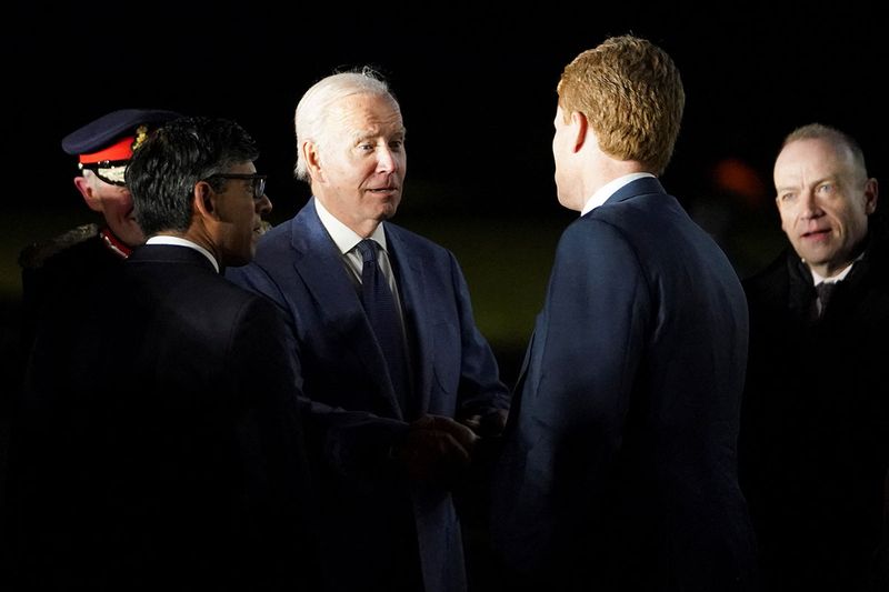 U.S. President Joe Biden meets with Robert Kennedy, next to British Prime Minister Rishi Sunak, on his arrival at RAF Aldergrove airbase in County Antrim, Northern Ireland April 11, 2023.