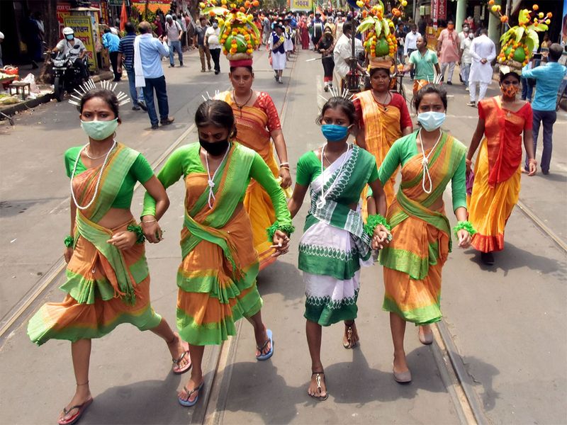 Women in traditional clothes walk holding hands in a celebration rally on the occasion of the Bengali new year in Kolkata.   