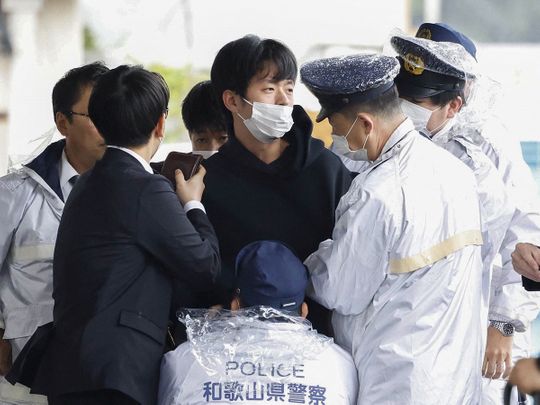 A man, believed to be a suspect who threw an apparent smoke bomb at Japanese Prime Minister Fumio Kishida