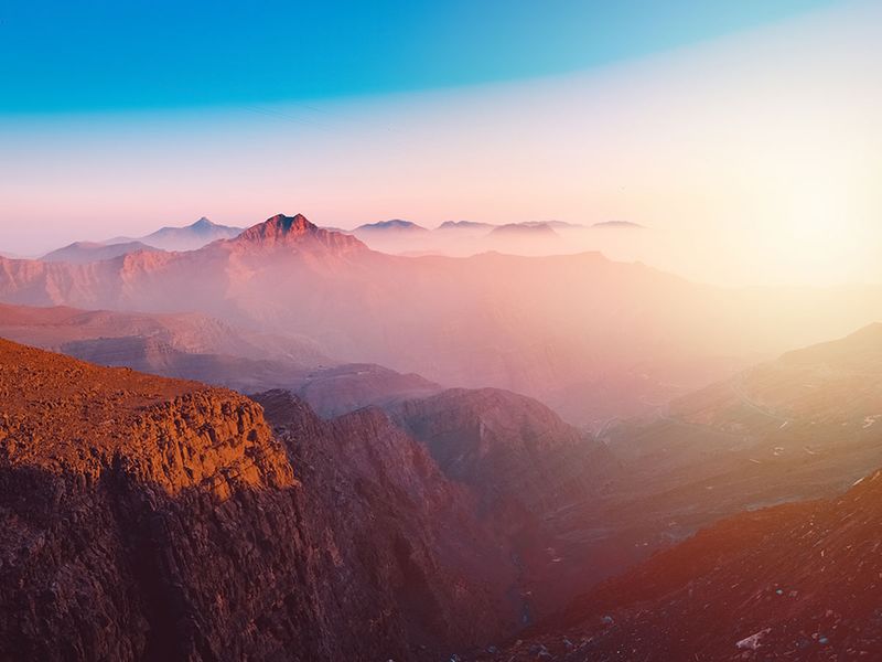 A view of the majestic Jebel Jais mountain in Ras Al Khaimah, United Arab Emirates from the highest viewing area during sunset.