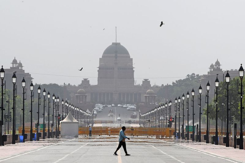 A mirage is seen in front of Rashtrapati Bhavan on a hot summer afternoon, at Kartavya Path, in New Delhi on Tuesday.
