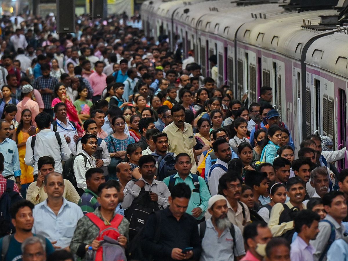 People crowd on platforms as they wait for their train at the Chhatrapati Shivaji Terminus (CST) railway station Mumbai on April 19, 2023.  