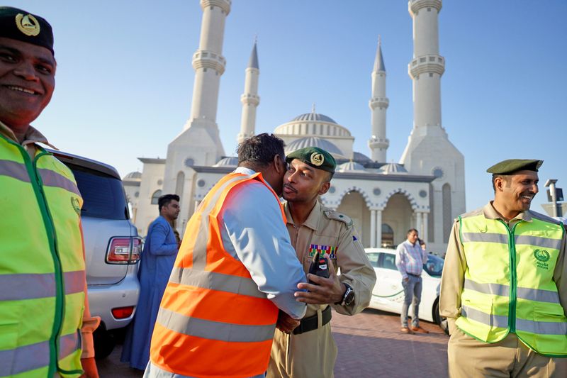 Dubai Police personnel greet people on the occasion of Eid Al Fitr. 