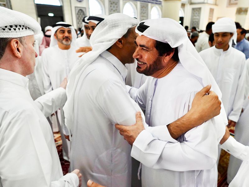 Emirati people greet each other on the occasion of Eid Al Fitr, at the Al Farooq Omar Bin Al Khattab Mosque (Blue Mosque) premises in Dubai. 