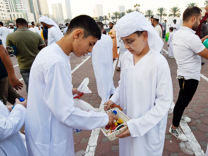 Kids distributing sweets after Eid Al Fitr prayer in Sharjah. 