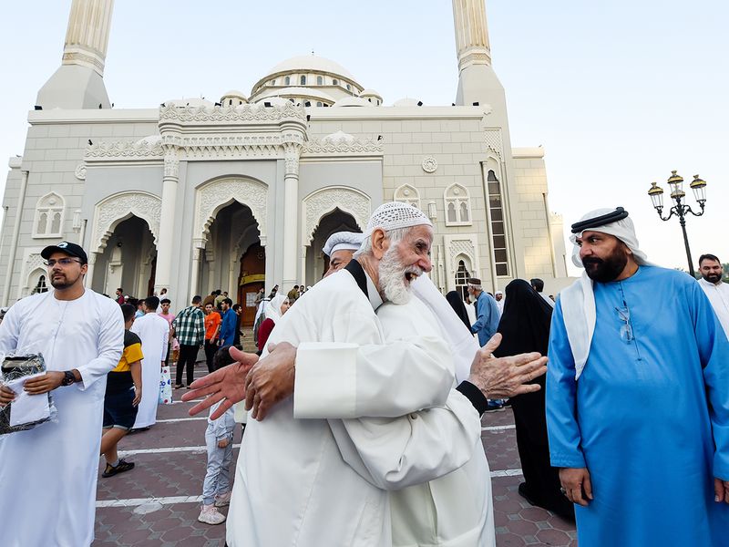 People greet each other after Eid Al Fitr prayer at Al Noor mosque in Sharjah. 