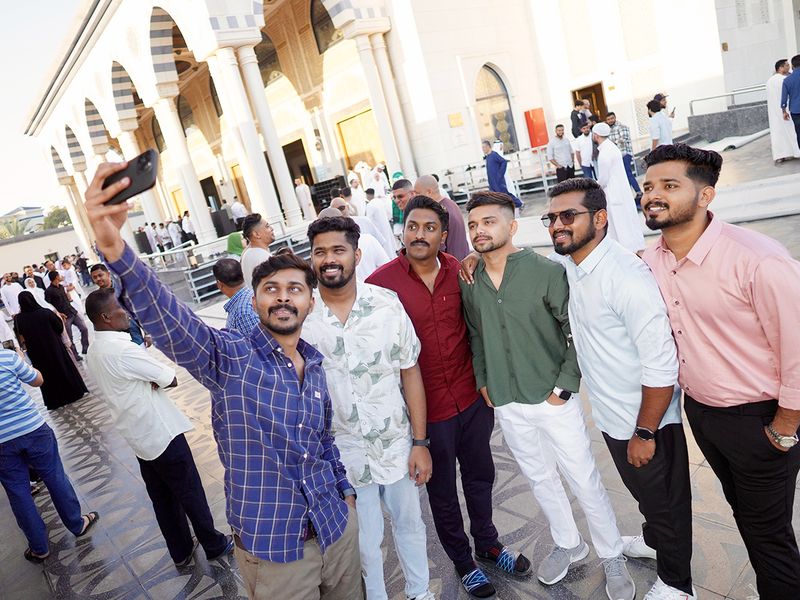 Residents pose for a selfie outside a Dubai mosque after offering morning Eid prayers. 