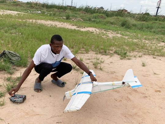 Bolaji Fatai prepares to fly a model aeroplane made from discarded waste, in Lagos, Nigeria. 