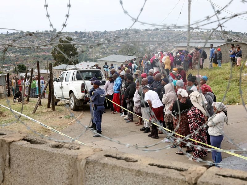 Residents look on at the scene of a deadly mass shooting near Pietermaritzburg, South Africa on April 21, 2023. 