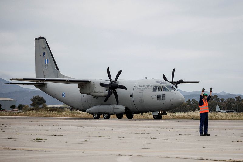 A Hellenic Air Force C-27J Spartan carrying Greek nationals who have been evacuated from Sudan arrives at a military airport in Elefsina, Greece, April 25, 2023. 
