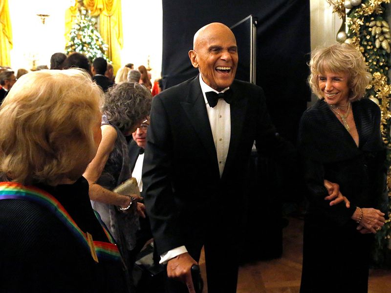 Harry Belafonte (C) laughs with a fellow audience member as they depart after a reception for the 2013 Kennedy Center Honors recipients at the White House in Washington, December 8, 2013. 