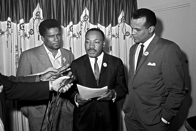 James Foreman, executive secretary of the Student Non-violent Coordinating Committee, left, Civil Rights leader Dr. Martin Luther King Jr., center, head of the Southern Christian Leadership Conference and activist-singer Harry Belafonte appear during a press conference in Atlanta on April 30, 1965. 