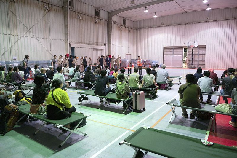 Japanese nationals who have been evacuated from Sudan listen to an explanation about entry procedure to Japan, in Djibouti, in this photo taken by Kyodo on April 24, 2023.   