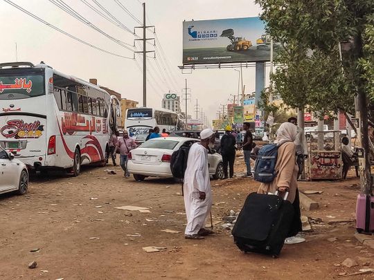 People prepare to board a bus departing from Khartoum 