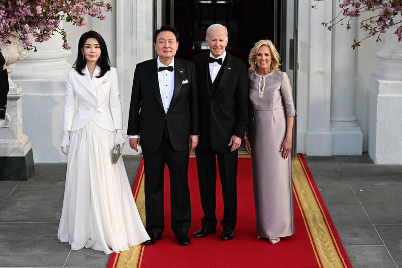 South Korean President Yoon Suk Yeol (2nd L) and his wife Kim Keon Hee (L) pose with US President Joe Biden (2nd R) and US First Lady Jill Biden (R) ahead of a State Dinner at the White House in Washington, DC, on April 26, 2023