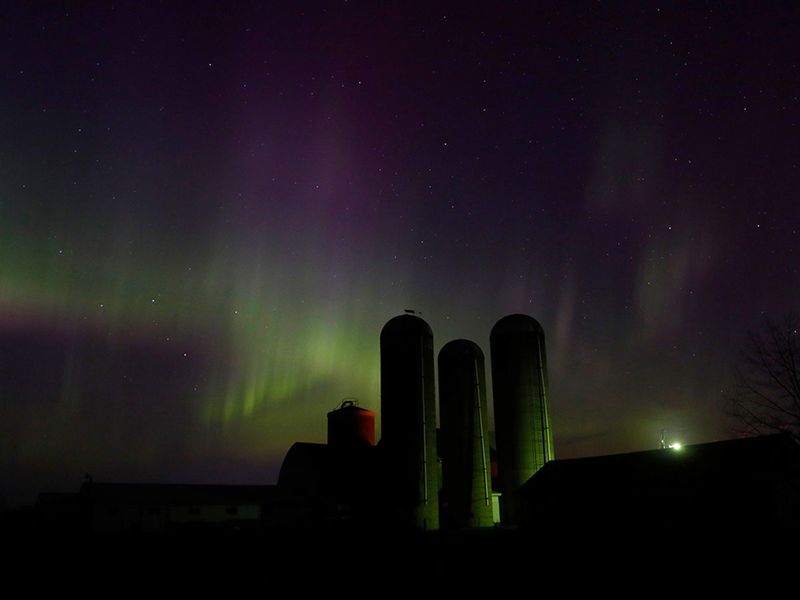 The northern lights are seen over a farm near Pulaski, Wis., on Sunday, April 23, 2023. An intense solar storm has the aurora borealis gracing the skies farther south than usual.