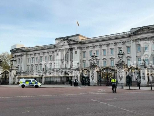 This image from a video shows police officers standing outside Buckingham Palace, where a man was arrested late Tuesday on suspicion of possessing an offensive weapon, London police said, in London, Tuesday, May 2, 2023.