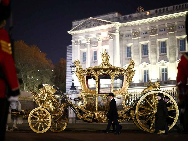 The Gold State Coach is ridden alongside members of the military during a full overnight dress rehearsal of the Coronation Ceremony of Britain’s King Charles and Camilla, Queen Consort in London, Britain, May 3, 2023.