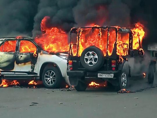 Vehicles burn after they are set ablaze in a recent clash between warring groups in Manipur’s Churachandpu.