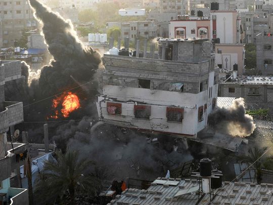 A house being hit by an Israeli air strike in Gaza city on Saturday. 