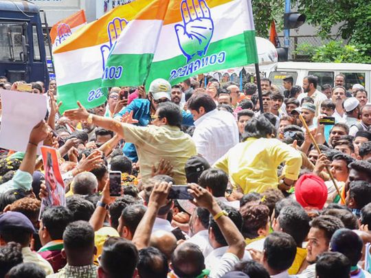 Congress workers and supporters hold party flags celebrate the party's victory in the Karnataka assembly elections, in Bengaluru on Saturday. 