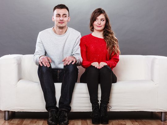 Man and woman sitting next to each other on a sofa