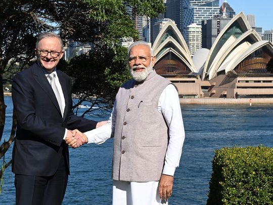 India's Prime Minister Narendra Modi (R) shakes hands with Australia's Prime Minister Anthony Albanese 