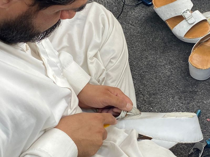 Abdul Haleem, who specialises in repairing leather items like shoes, belts and purses, working on a customer's pair of shoes.