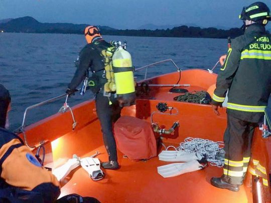 Firefighters search for survivors after a tourist boat capsized in Lake Maggiore, in northern Italy. 