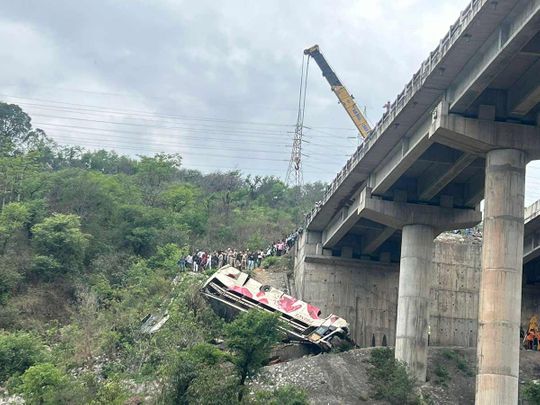 Rescuers prepare to use a crane after a bus carrying Hindu pilgrims to a shrine skid off a highway bridge into a Himalayan gorge near Jammu