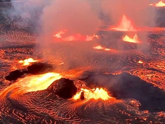 Lava flows on the Halema'uma'u crater floor alongside several active vent sources as the Kilauea volcano erupts in Hawaii.