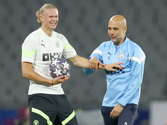 Manchester City  manager Pep Guardiola (R) with Manchester triker Erling Haaland during a training session at the Ataturk Olympic Stadium in Istanbul on June 9, 2023. 