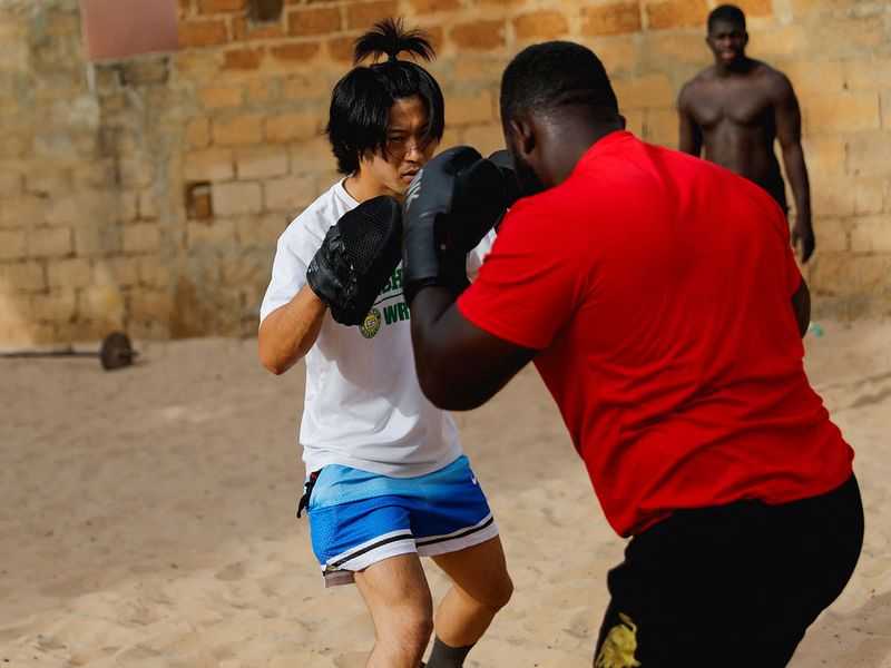 Shogo Uozumi trains with his teammates at the Samba Dia stable in the Diakhao neighbourhood, in Thies, Senegal. 