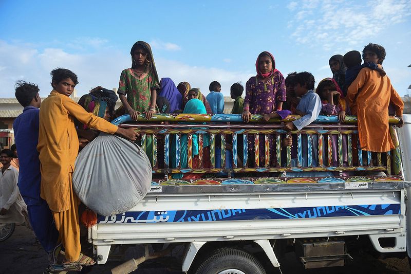 Cyclone evacuees arrive at a temporary shelter set at a school in Badin district of Pakistan's Sindh province on June 14, 2023, ahead of cyclone Biporjoy landfall. More than 100,000 people have been evacuated from the path of a fierce cyclone heading towards India and Pakistan, with forecasters warning on June 14 it could devastate homes and tear down power lines.