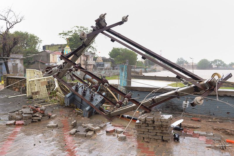 Damaged electric transformers are seen on the ground in Mandvi town. 