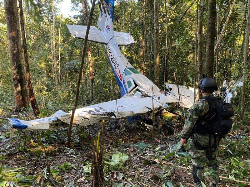 A soldier stands in front of the wreckage of a Cessna C206 on May 18, 2023, that crashed in the jungle of Solano in the Caqueta state of Colombia. 