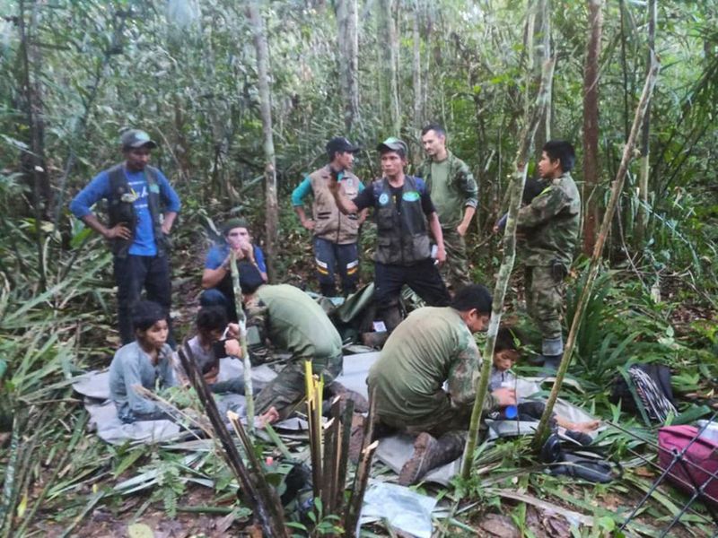 Soldiers and Indigenous men tend to the four Indigenous children who were missing for 40 days after surviving a deadly plane crash, in the Solano jungle, Caqueta state, Colombia, June 9, 2023. 