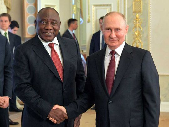 Russian President Vladimir Putin (R) shaking hands with South Africa's President Cyril Ramaphos