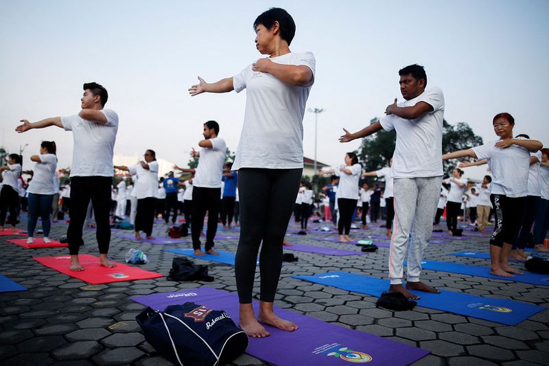 People perform Yoga on the International Day of Yoga in Batu Caves, Selangor, Malaysia June 21, 2023.