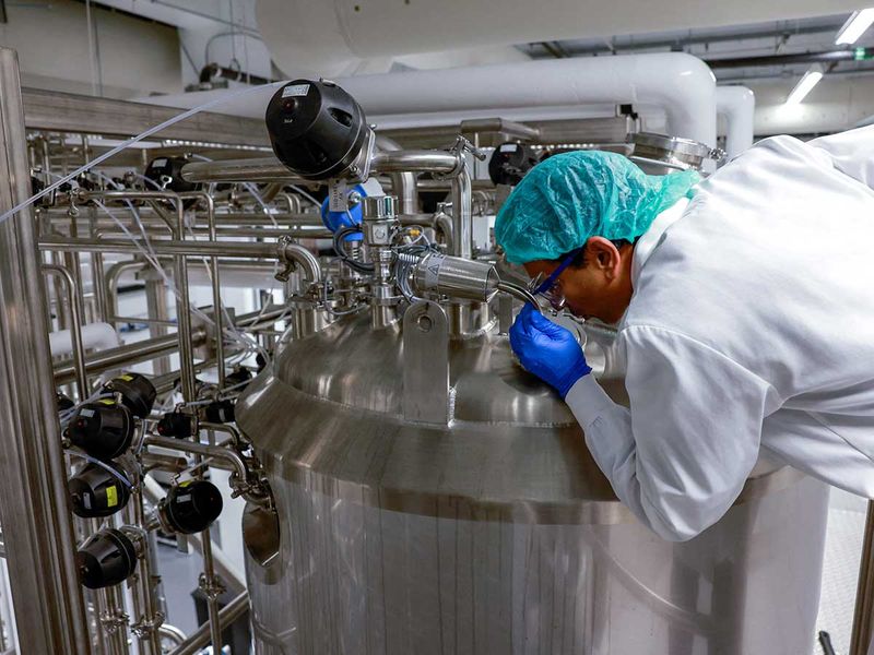 Founder & CEO Uma Valeti peers into one of the cultivation tanks at the Upside Foods plant, where lab-grown meat is cultivated, in Emeryville, California. 