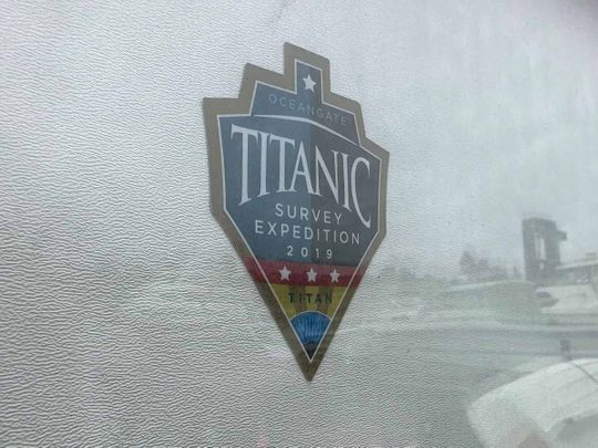 The logo for an OceanGate Expeditions 2019 Titanic expedition is seen on a marine industrial warehouse office door in Everett, Wash., Tuesday, June 20, 2023.