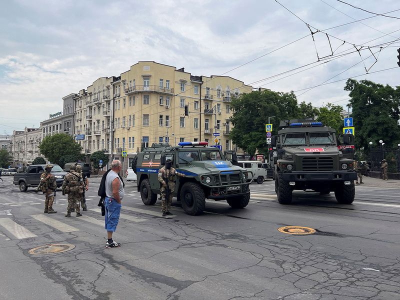 Fighters of Wagner private mercenary group stand guard in a street near the headquarters of the Southern Military District in the city of Rostov-on-Don, on June 24, 2023. 