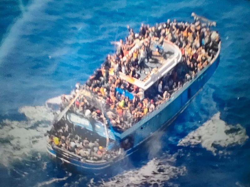 This undated handout image provided by Greece's coast guard on Wednesday, June 14, 2023, shows scores of people on a battered fishing boat that later capsized and sank off southern Greece. 