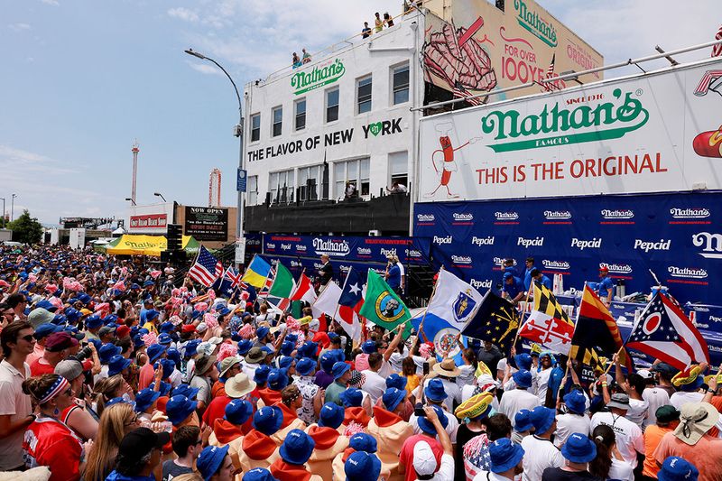 People gather for the 2023 Nathan's Famous Fourth of July International Hot Dog Eating Contest at Coney Island in New York City, U.S., July 4, 2023.