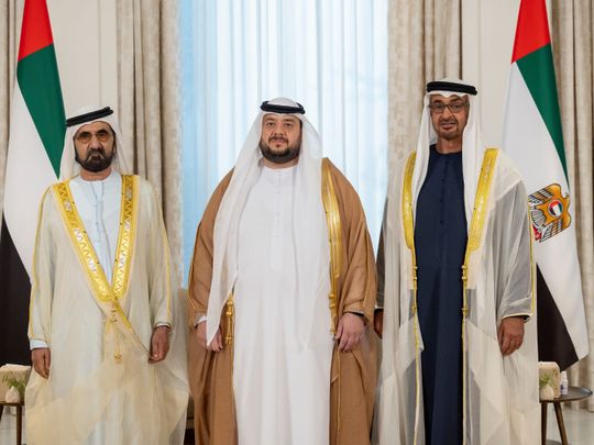 His Highness Sheikh Mohamed bin Zayed Al Nahyan, President of the United Arab Emirates (R), and His Highness Sheikh Mohammed bin Rashid Al Maktoum, Vice-President, Prime Minister of the UAE, Ruler of Dubai and Minister of Defence (L), stand for a photograph with newly appointed minister, Mohamed Hassan Al Suwaidi, UAE Minister of Investment (C), during oath ceremony at Shati Palace. 